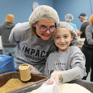 Sandra Torre and her daughter, Madeline, pack food for Feed My Starving Children.